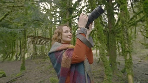 Woman Photographer Taking Photos in a Mossy Forest