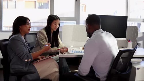 Coworkers discussing business strategy in modern office