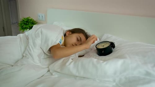 Child Sleeping Soundly, Reaches for Alarm Clock