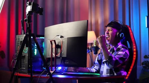 Excited Young Adult Gamer Playing Video Game