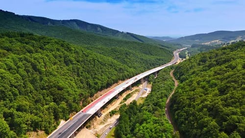 Road winds through green mountains.