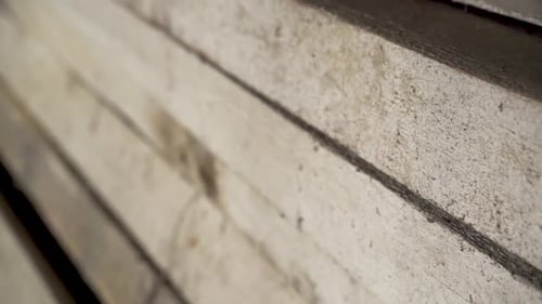 Stack Of Wood Lumber In An Old Shed. - close up