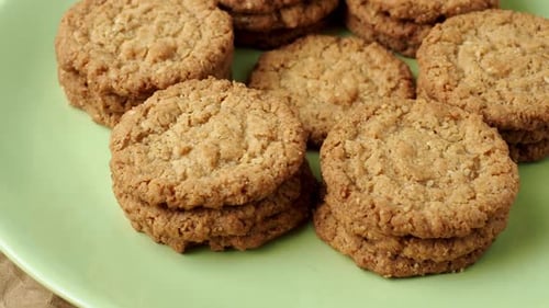 Tasty cookies biscuits. Stack of sugar cookies biscuits in green plate.