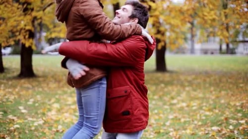 Couple Embrace and Spin in Fall Park