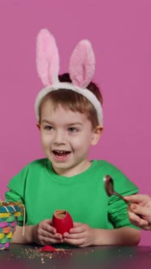 Vertical Video Ecstatic Kids Breaking a Special Easter Egg to Find a Surprise Inside