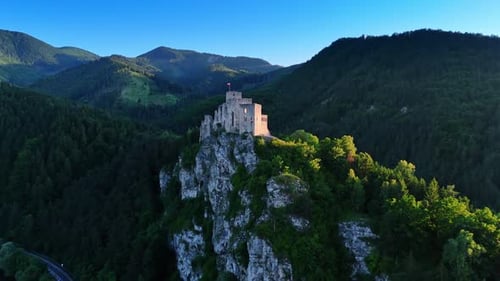 View of a medieval fortress atop a hill. A stunning medieval castle sits on a rocky hill