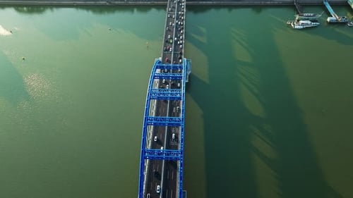 Aerial View of a Busy Bridge with Cars Crossing Over Water During Daylight