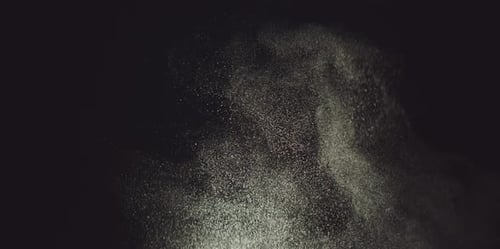 Dust Particles Floating Upward Against Dark Background