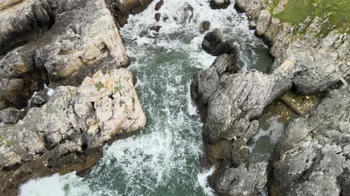 Ocean Waves Crashing on Rocky Cliffs from Above