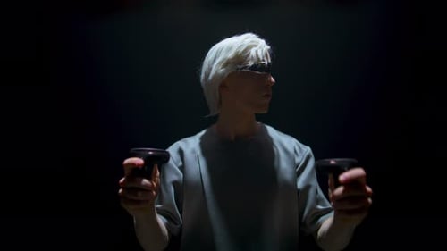 Teenager Using Vr Controllers in Dark Room. Cyber Player Enjoying Augmented Reality