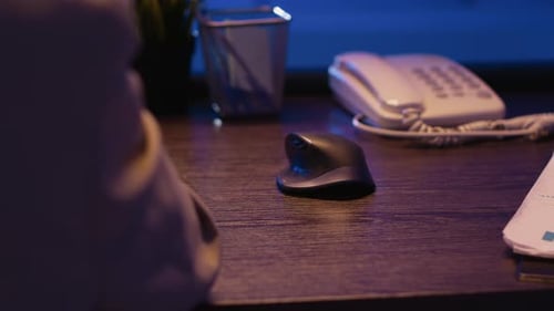 Office Employee Analyzing Economy Charts at Desk