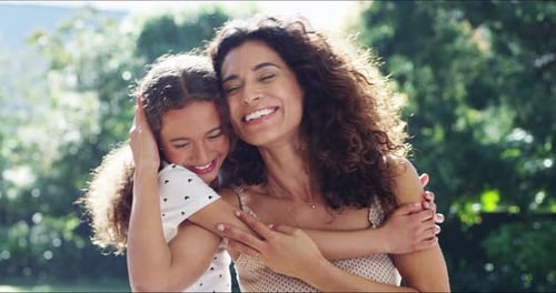 4k video footage of a cheerful young girl hugging her mother outside at home during the day