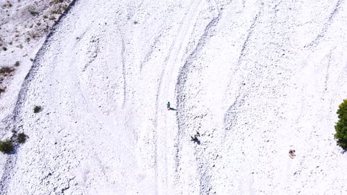 A young hiker walking along the dry river in summer through the Valbona valley, Theth national park,