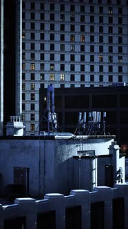 Urban Skyline Features Rooftops Adorned with Antennas at Night