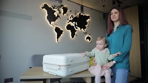 Young Woman and Child with Suitcase in Home