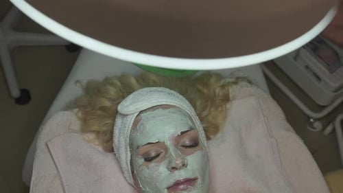 Woman With Facial Mask on Skin Care Treatment in Spa Salon, Dermatology and Anti Aging Concept, High
