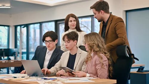 Business meeting in an office, workers discussing business affairs using gadgets and papers. Slow mo