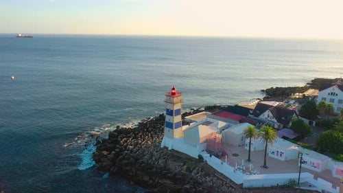 Drone Shot of Santa Marta Lighthouse and Seascape Cascais Portugal at Sunset