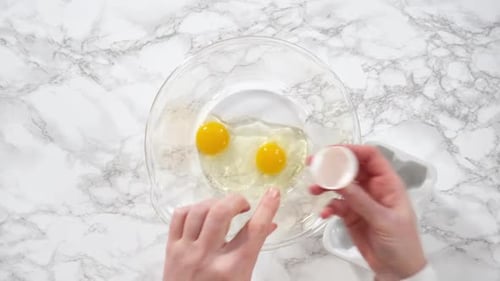 Flat Lay Mixing Ingredients in a Glass Mixing Bowl to Bake a Chocolate Cupcake