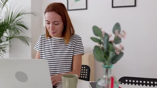 Young Freelancer Woman Using Laptop Working at Home Office
