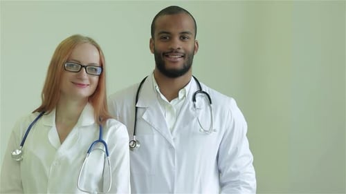 Doctors Smiling Wearing Stethoscopes and White Coats