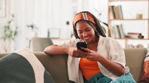 Woman Using Smartphone on Couch Indoors