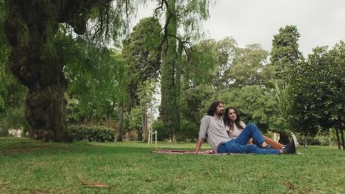 Couple Relaxing on Blanket in Green Park