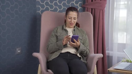 Woman Using Cell Phone then Plugging it In