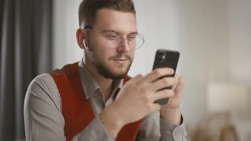 Young Man Scrolling Smartphone