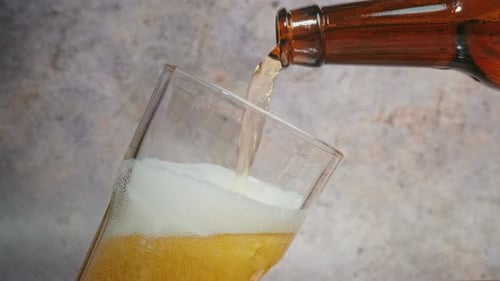 Cold craft light Beer is pouring from bottle