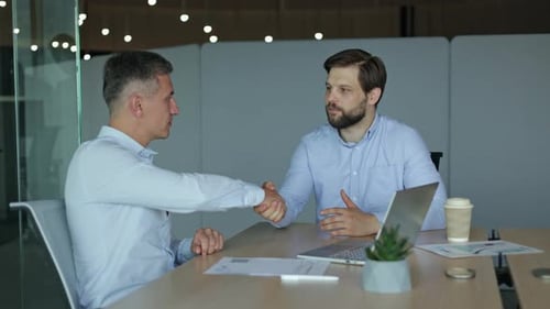 Businessmen Meeting in Office Agreeing and Shaking Hands