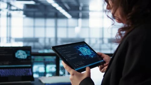 Engineer in Data Center with Tablet Integrating AI Driven Automation Tools