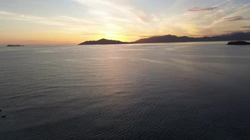 Aerial view of sunrise over the sea. flying over water into a beautiful sunrise