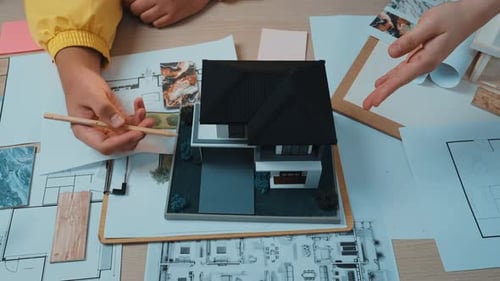 Architects Reviewing House Design Plans and Model