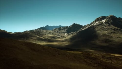 Majestic Mountain Landscape at Sunrise Showcasing Rugged Terrain and Shadows