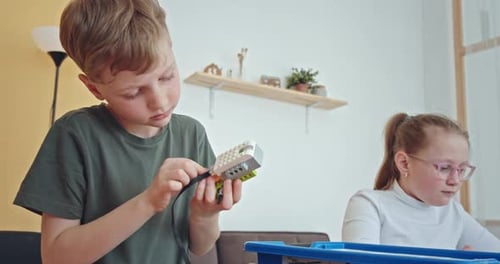 Curious Kids Working on a Functional Programable Robot During Robotics Class at School