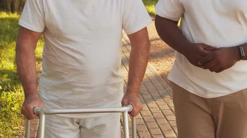 AfricanAmerican Caregiver and Old Man Professional Nurse and Patient in a Nursing Home Assistance