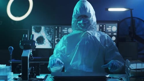 Scientist in Hazmat Suit Working at a Computer