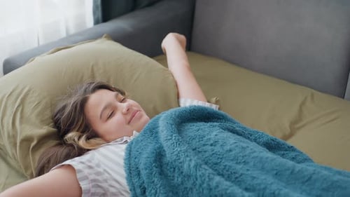 Teenage Girl Waking Up, Stretching in Bed