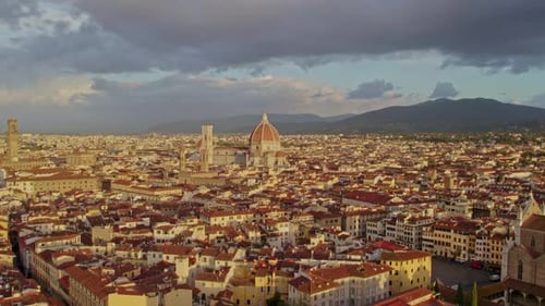 Aerial view of Cathedral and city rooftops at sunrise, Italy.