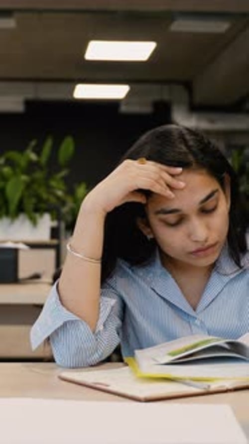 Tired Student Feeling Exhausted and Overworked in Library