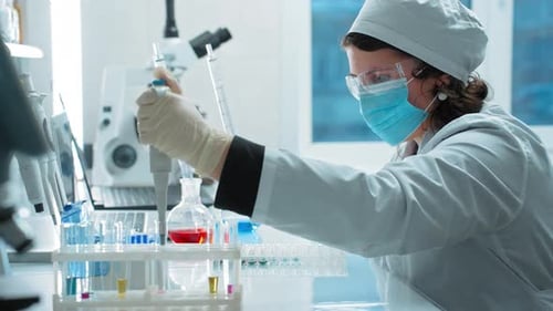 Medical Researcher Works With Pipette in Bright Lab