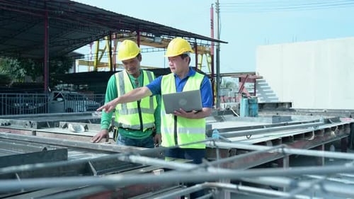 Construction supervisor monitors progress and supervises important construction