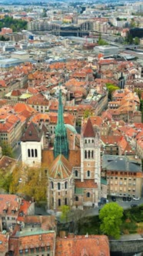 Aerial, drone view of the buildings surrounding the St Pierre Cathedral in Geneva, Switzerland. Vert