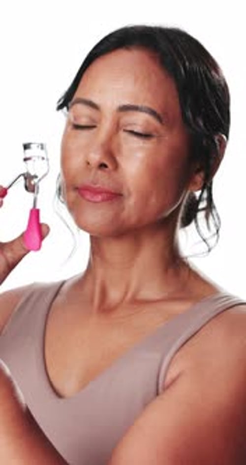 Eyelash curler, face and woman in studio for cosmetics, volume and length boost in mascara prep