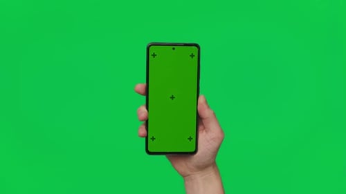 Male Hand Holding a Smartphone with Vertical Green Chroma Key Screen Isolated on Green Mobile Phone