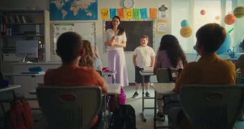 Teacher Interacts With Students in Classroom Environment