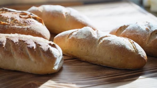 Freshly Baked Bread on Wooden Background in Bakery Shop