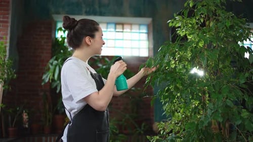 Running of Own Business Young Woman Florist with Spray Bottle Watering Fertilizing Plants in