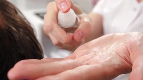 Serum Being Poured into Woman's Hand